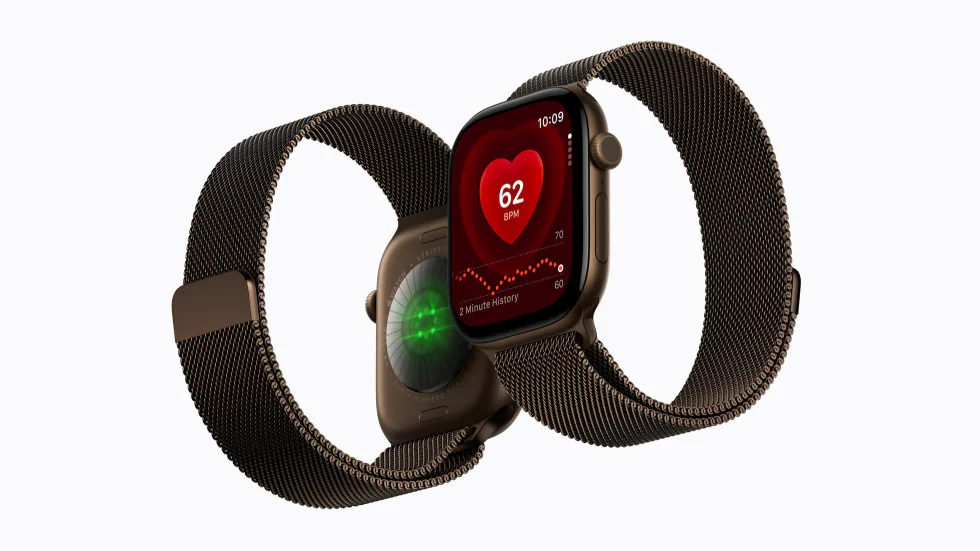 Apple Watch Series 12 with a bronze Milanese Loop, from the front showing the Heart Rate app and from the back showing its health sensors